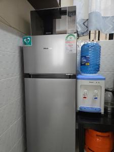 a refrigerator in a kitchen next to a counter at Mina Luxe Machakos in Machakos