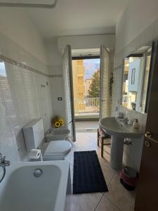 a bathroom with a tub and a toilet and a sink at VALTELLINA SONDRIO HOLIDAYS in Sondrio +34 photos
