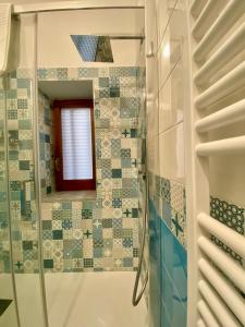 a bathroom with a shower and a mirror at Matteo's Home in Vietri sul Mare +29 photos