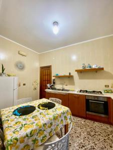 a kitchen with a table and a refrigerator at Matteo's Home in Vietri sul Mare