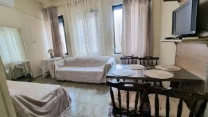 a living room with a table and a couch at Julieta's house in Chios