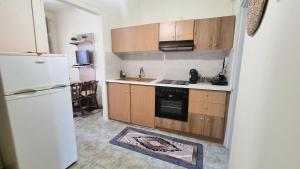 a kitchen with a refrigerator and a stove at Julieta's house in Chios