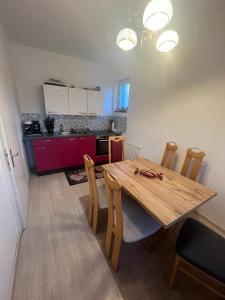 a dining room with a wooden table and chairs at Wohnung Sonja in Villach