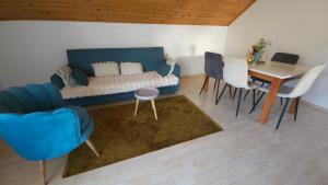 a living room with a couch and a table and chairs at Villa Ruscello in Grabovac