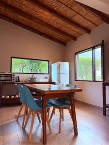 a dining room with a wooden table and chairs at Barcena Houses in Tumbaya