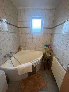 a bath tub in a bathroom with a window at Wohnung Sonja in Villach