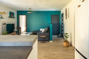 a living room with blue walls and a couch at Villa Coeur Bleu in Petit-Bourg +18 photos