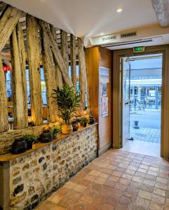 an entrance to a building with plants on a wall at Entre Terre Et Mer in Honfleur +42 photos
