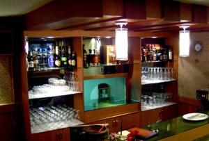 a bar with a lot of bottles and glasses at Luxury Hotel in Osan