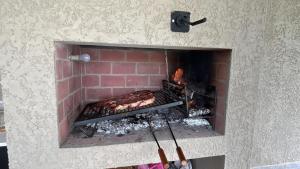 a brick oven with food cooking in it at La Hojarasca in Termas de Guaviyú