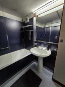 a bathroom with a sink and a tub and a toilet and a sink at Residenza 404 in Ivrea