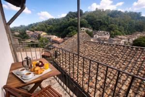 a table with a plate of food on a balcony at Casa del Borgo, between Mountains and Lake, Near Rome in Canepina