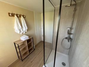 a bathroom with a shower with a glass shower stall at La Rosée du Cardou in Gavaudun