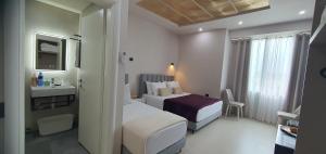 a hotel room with two beds and a bathroom at RADIO HOTEL Lushnje in Lushnjë