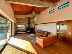 a living room with a couch and a fireplace at Quinta Vale da Roca in Sintra