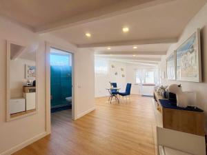 a living room with a table and a dining room at Syrene Suites Sorrento in Piano di Sorrento