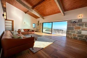 a living room with a couch and a stone fireplace at Quinta Vale da Roca in Sintra