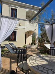a patio with chairs and a table and a building at Vista Blue Villa in Budva