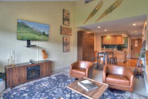 a living room with a couch and chairs and a tv at Tamarron Lodge Loft 510 in Durango