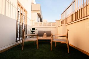 a balcony with a table and chairs and a computer on it at NUMA Beach Apartments in Aguadulce