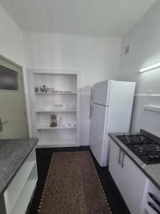 a kitchen with a white refrigerator and a stove at appartement Rabat Gare à 3min,Rabat honey house in Rabat +7 photos
