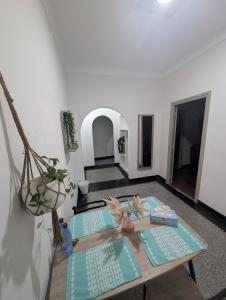 a living room with a table and a room with at appartement Rabat Gare à 3min,Rabat honey house in Rabat