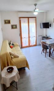 a living room with a couch and a table at ROSA BLU House Ospedale Cisanello Pisa in Pisa