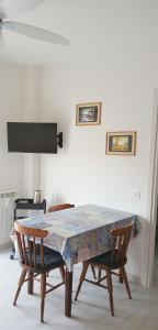 a dining room table with two chairs and a table with a patterned table at ROSA BLU House Ospedale Cisanello Pisa in Pisa