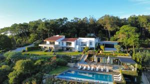 an aerial view of a house with a swimming pool at Quinta Vale da Roca in Sintra