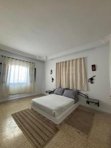 a white bedroom with a bed and a window at Jardins de Mezraya in Mezraya +17 photos