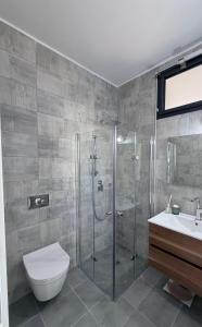 a bathroom with a shower and a toilet and a sink at Bat Yam apartment in Bat Yam +7 photos