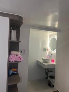 a bathroom with a sink and a mirror at Êm Attic Hai Phong Old Town in Hai Phong