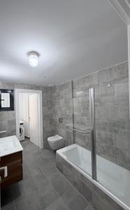 a bathroom with a tub and a toilet and a sink at Bat Yam apartment in Bat Yam