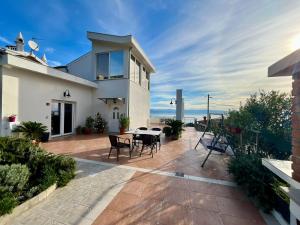 a house with a patio with a table and chairs at Villa Kubo in Lovran
