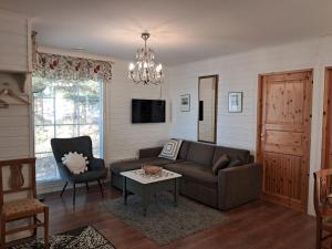 a living room with a couch and a table at Yyterin Villa Pyrylä in Yyteri