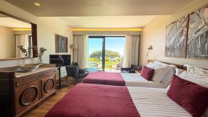 a hotel room with two beds and a television at Quinta Vale da Roca in Sintra +89 photos