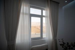 a window with a view of a desert view at Muscat Stays in Muscat
