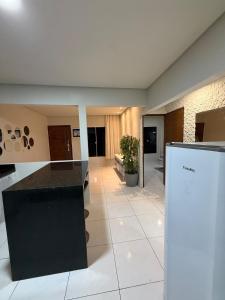 a kitchen with a black counter top in a room at Japaratinga CENTRO in Japaratinga +23 photos