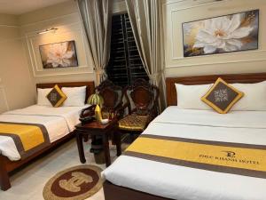 a hotel room with two beds and a window at hotel phúc khánh in An Dương