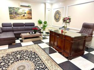 a living room with a couch and a table at hotel phúc khánh in An Dương