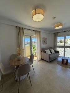 a living room with a table and a couch at NUMA Beach Apartments in Aguadulce
