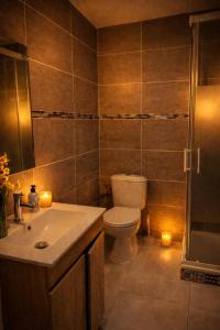 a bathroom with a toilet and a shower with candles at Le cocon de corbeil in Corbeil-Essonnes