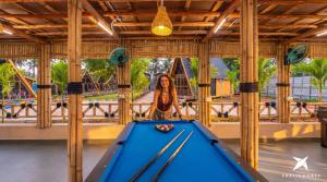 a woman standing in front of a pool table at Zostel Homes Hampi in Hampi +35 photos