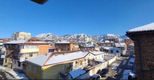 a view of a city with snowy mountains in the background at Hotel Velar in Korçë