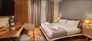 a hotel room with a bed and a desk at Hotel Velar in Korçë