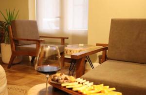 a tray of cheese and a glass of wine on a table at Hotel Velar in Korçë +13 photos