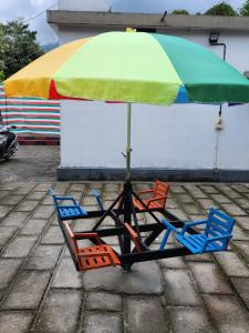 two beach chairs and an umbrella on a patio at W Villas in Padinjarathara