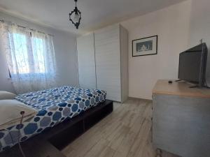 a bedroom with a bed and a television in it at Il Nido di Chiara 2 in Formia