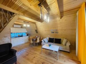 a living room with a couch and a table at Rakushki's House 2 in Tsikhisdziri in Kobuleti
