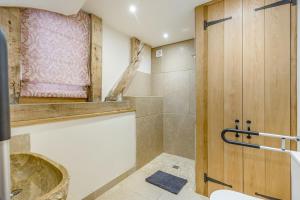 a bathroom with a shower and a sink and a toilet at Unique Luxury Barn in Tenbury +17 photos